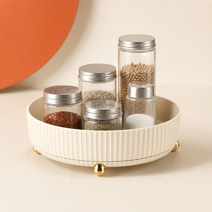 Cream rotating spice organizer with fluted sides and gold feet